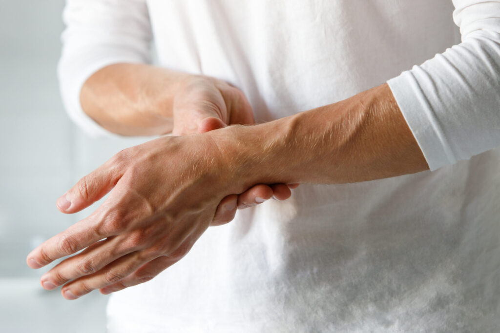 closeup of man arms holding painful wrist caused b 2025 03 08 12 02 55 utc