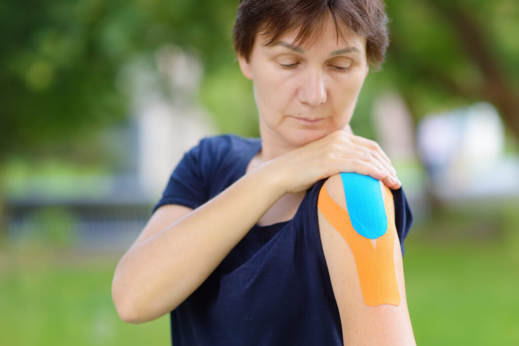 woman with kinesio tape on her shoulder kinesiolo 2025 02 22 02 26 33 utc