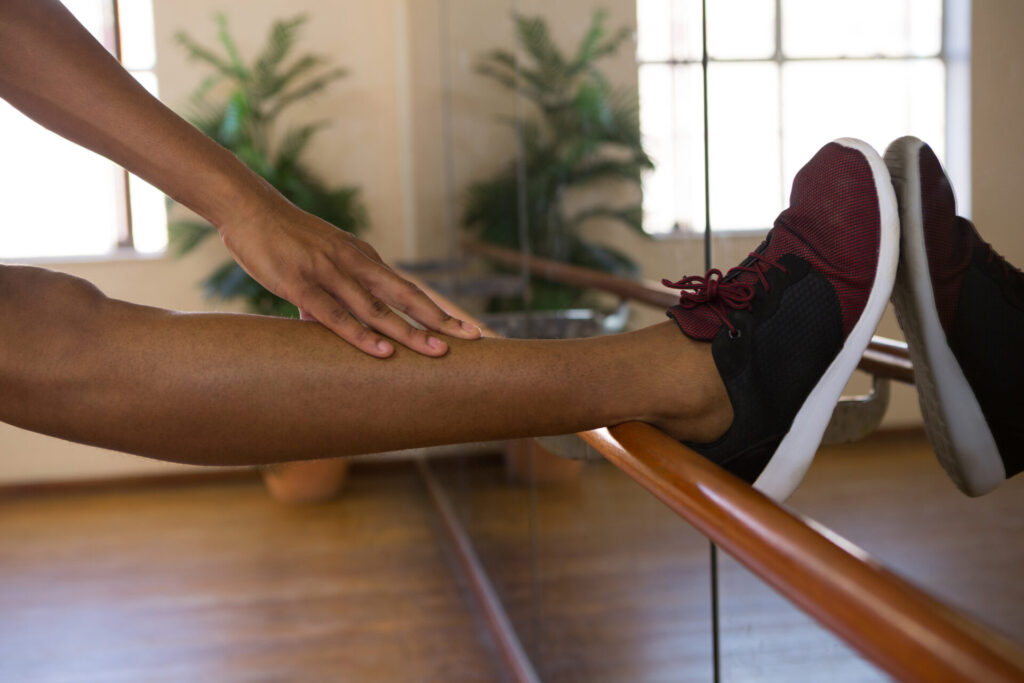 low section of male dancer stretching leg on barre 2025 10 28 21 52 16 utc
